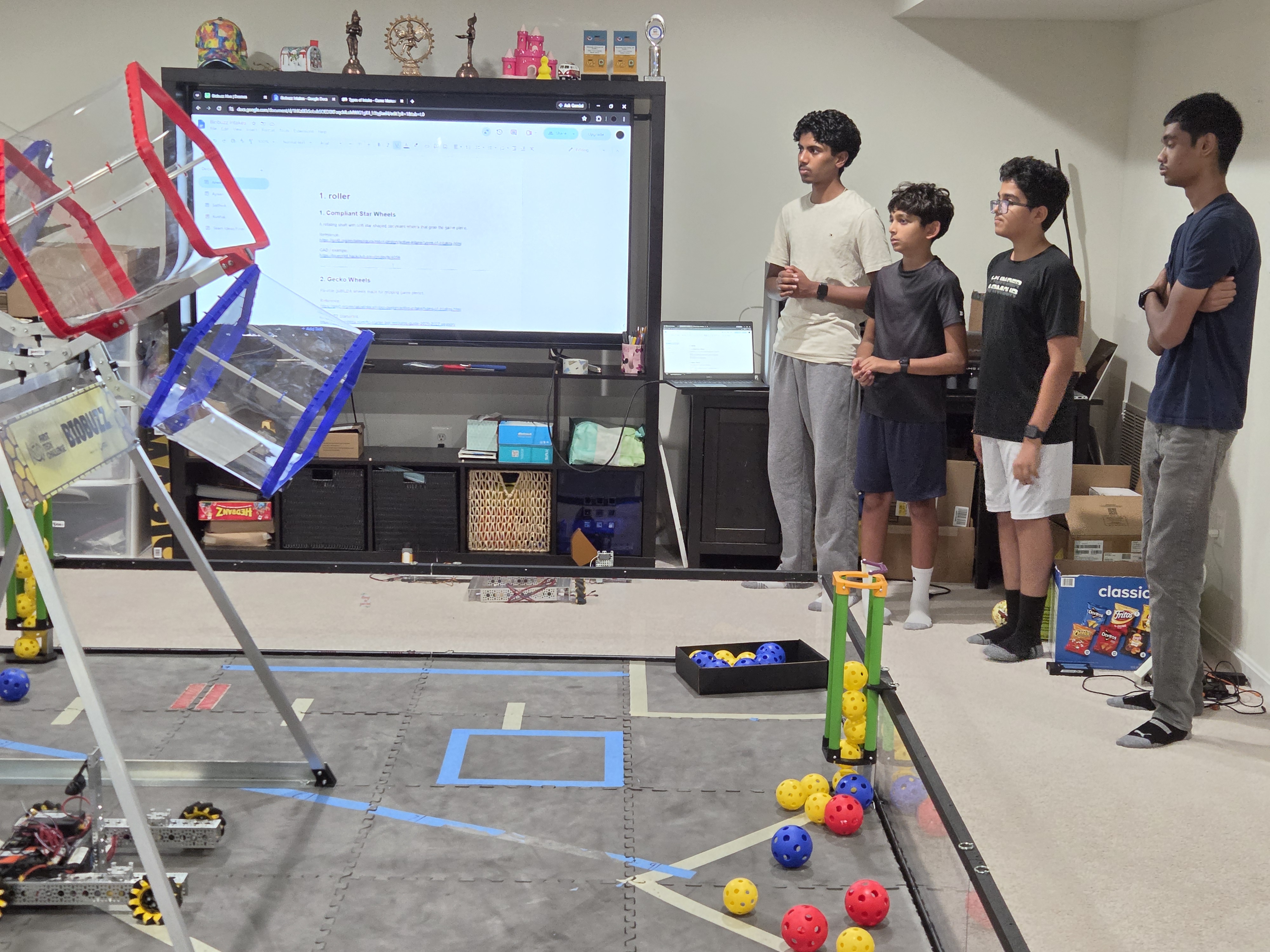 Robotechs team members sharing ideas beside their practice field
