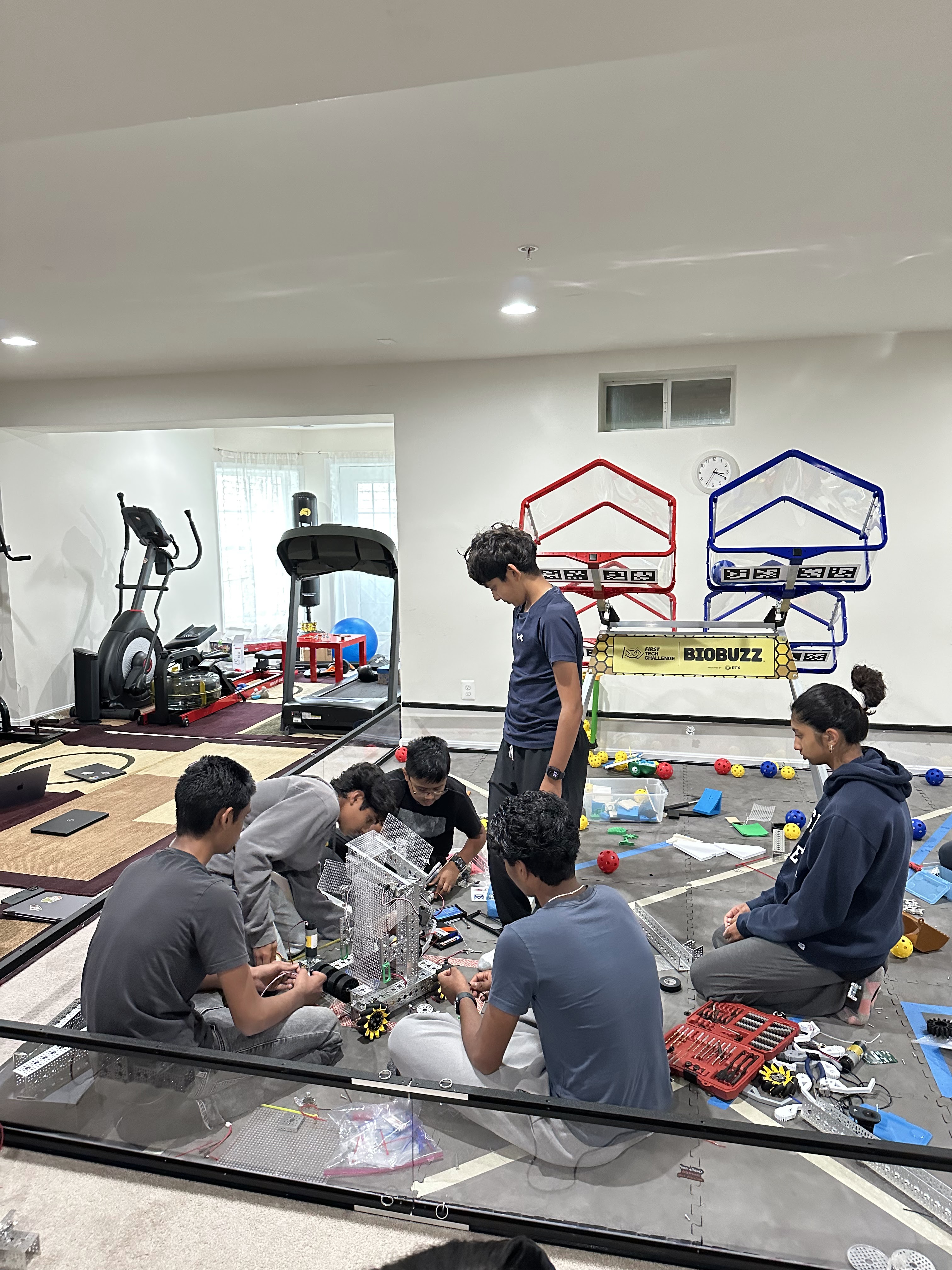 Robotechs team members building their robot together on the practice field