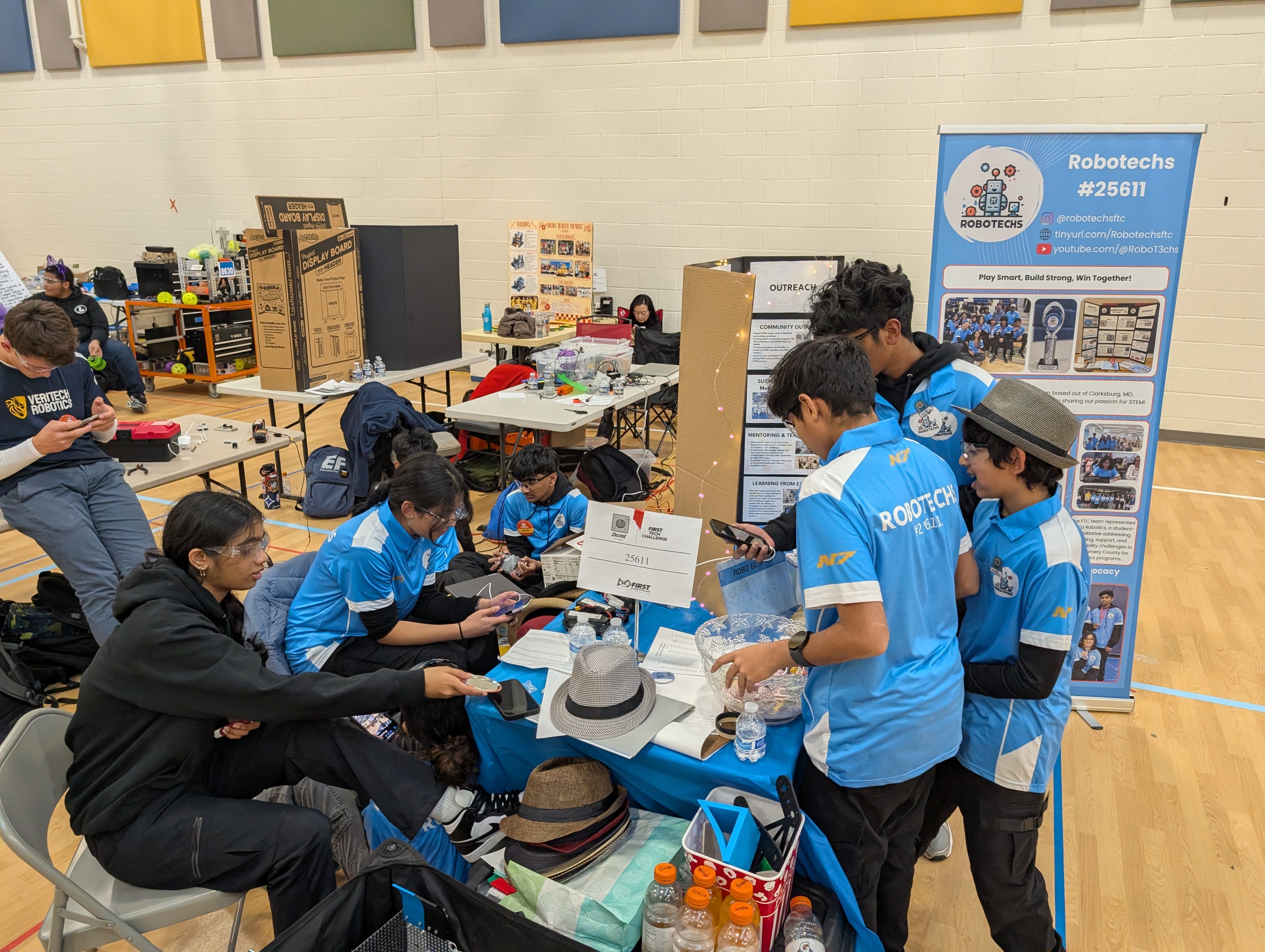 Robotechs working together at a competition table